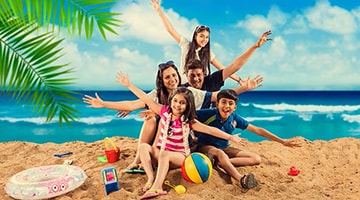 indian family playing in a beach abroad