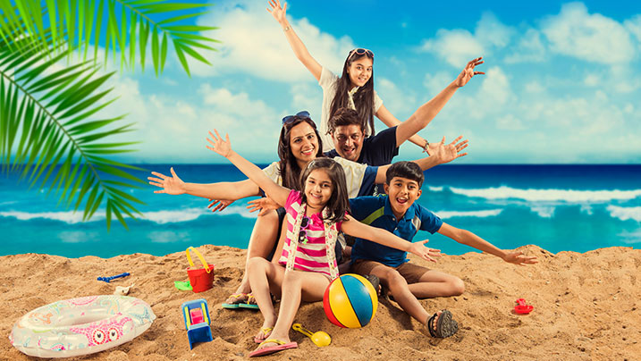 indian family playing in a beach abroad