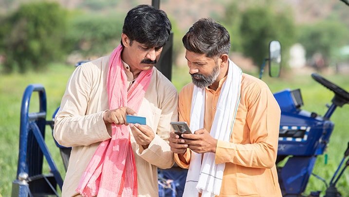 Two farmers usinf their Kisan Credit Card