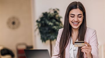 Happy working woman with credit card