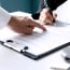 a person signing car insurance document