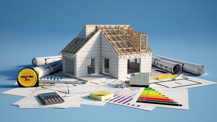 toy house under construction on top of documents