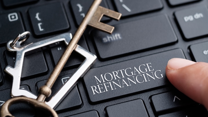 finger on keyboard with words Mortgage Refinancing