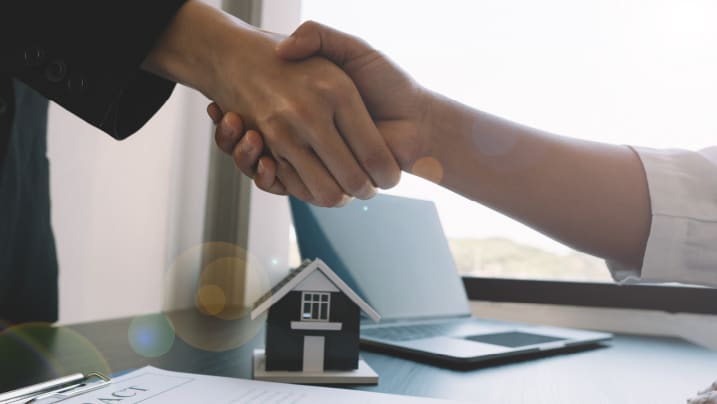 two people shaking hands for home loan agreement