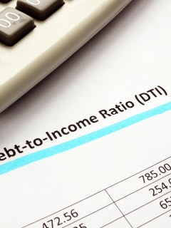 person using a calculator with a pen in hand