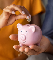 Couple Saving Money Through Piggy Bank