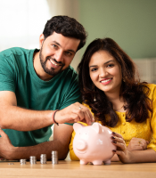 Couple Saving Money Through Piggy Bank
