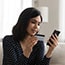woman using cellphone to avail credit card benefits