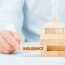 wooden model of the house with text insurance