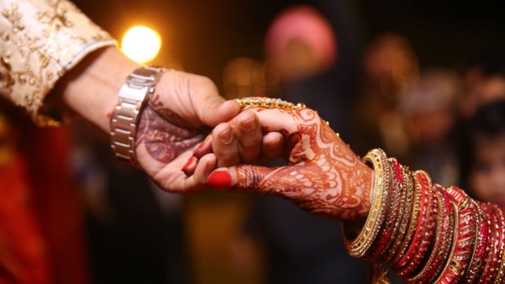 Indian wedding couple exchanging garlands
