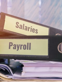 payroll and salaries folders stacked together